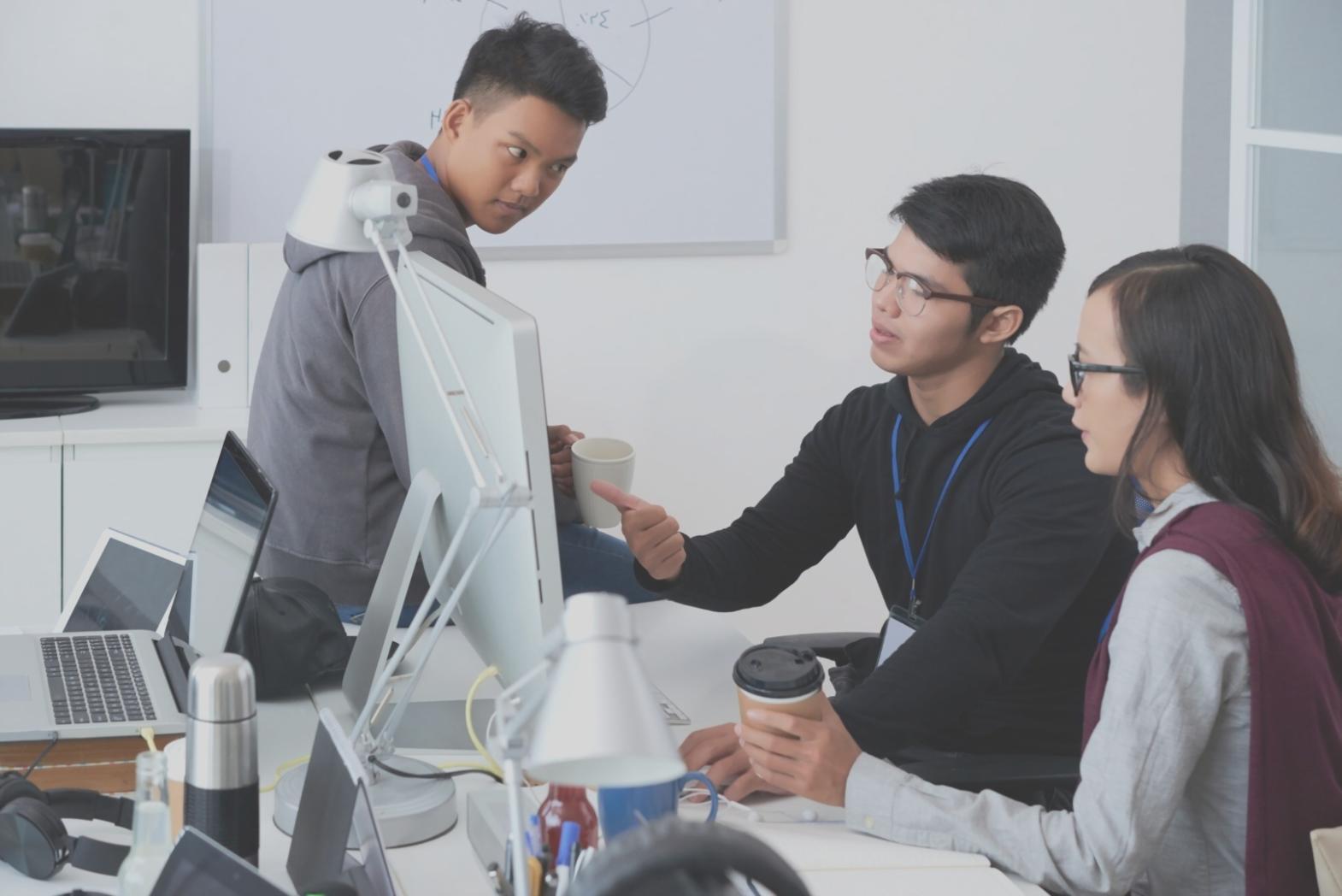 Workshop participants working on browser-based social casino game systems at Noltrona